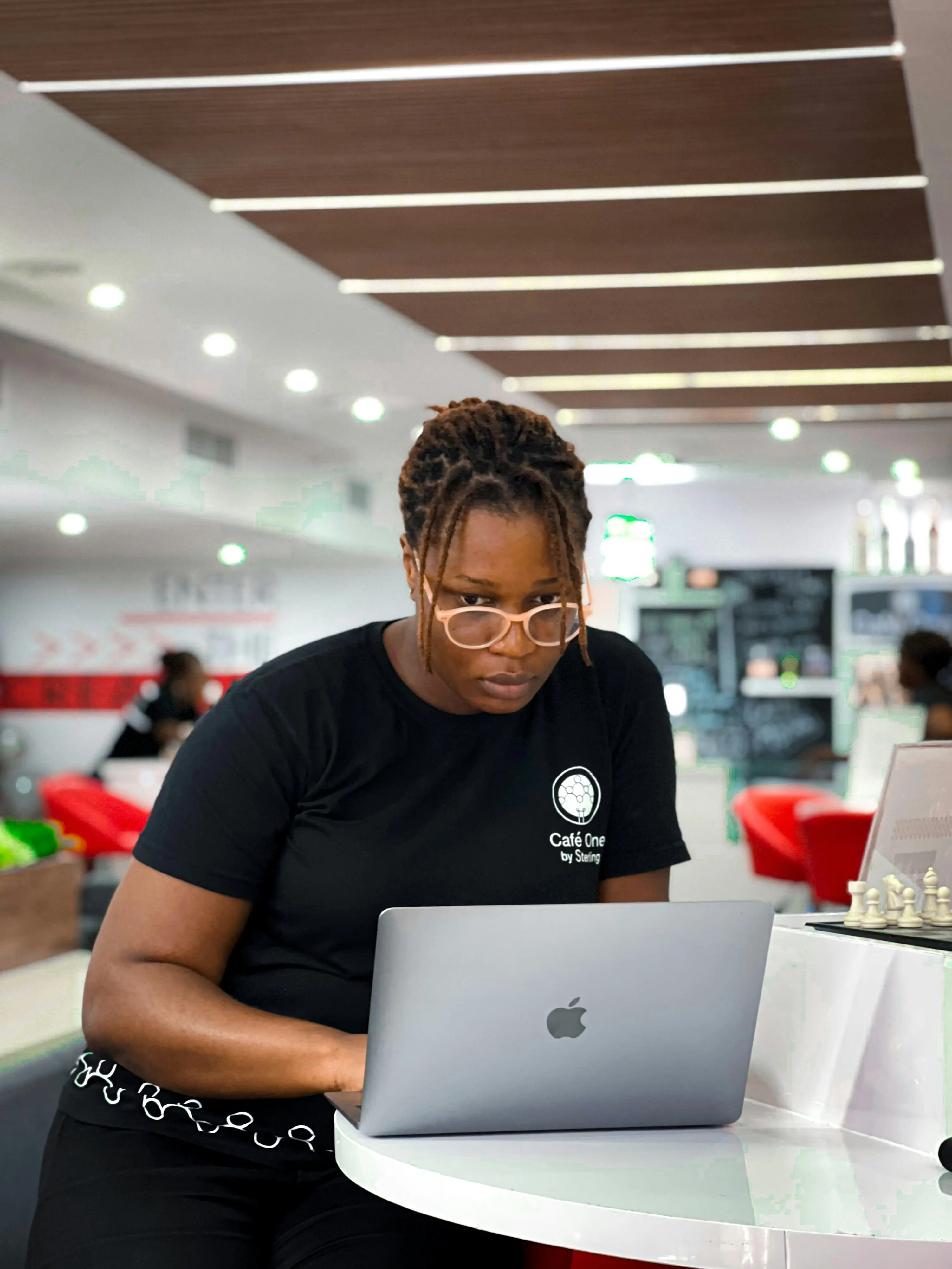 lady with laptop in hand and people at her back